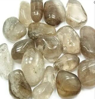 Smoky quartz tumbled stones on a white background.