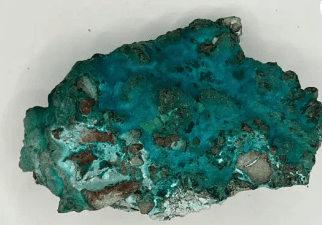 Rough turquoise gemstone with brown veins.