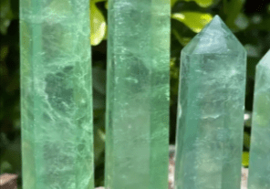 Four green fluorite crystal points.