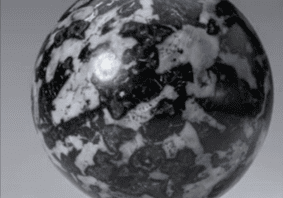 Black and white patterned sphere on stand.