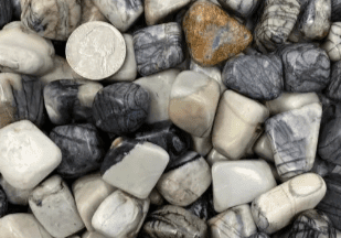 Close-up of tumbled zebra jasper stones.