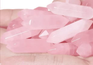 Hand holding a pile of pink crystals.