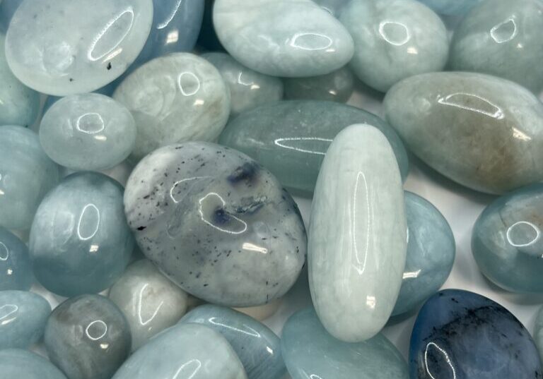 Aquamarine tumbled stones, light blue.