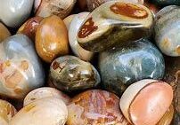 Smooth, colorful, polished stones in a pile.