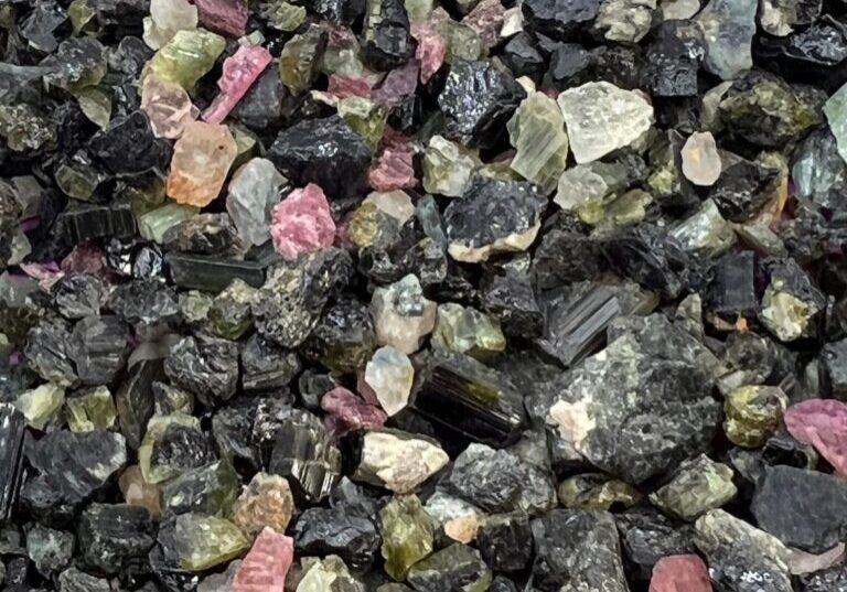 Collection of black, green, and pink stones.