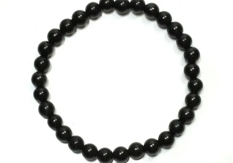 Black beaded bracelet on white background.