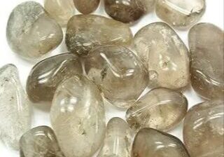 Smoky quartz tumbled stones on a white background.